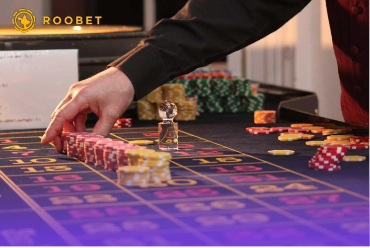 Dealer laying out chips on a casino table